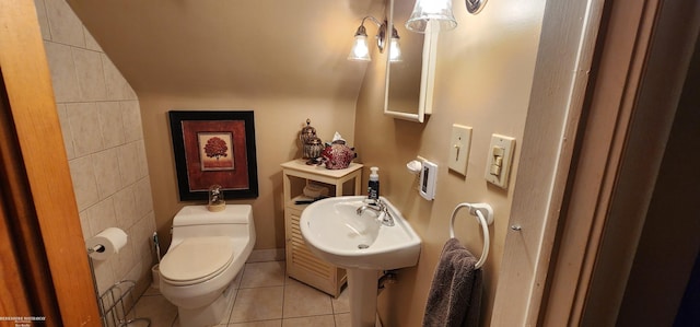 bathroom featuring tile patterned floors, toilet, and a sink