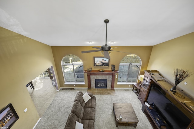 living area featuring carpet, a healthy amount of sunlight, and a fireplace