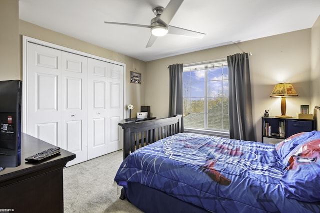 carpeted bedroom with a closet and a ceiling fan