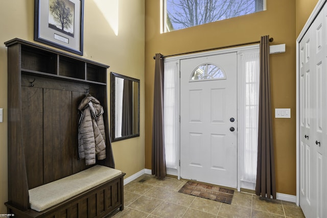 foyer entrance with tile patterned floors and baseboards