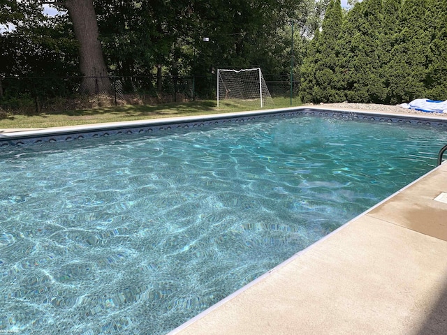 outdoor pool featuring fence