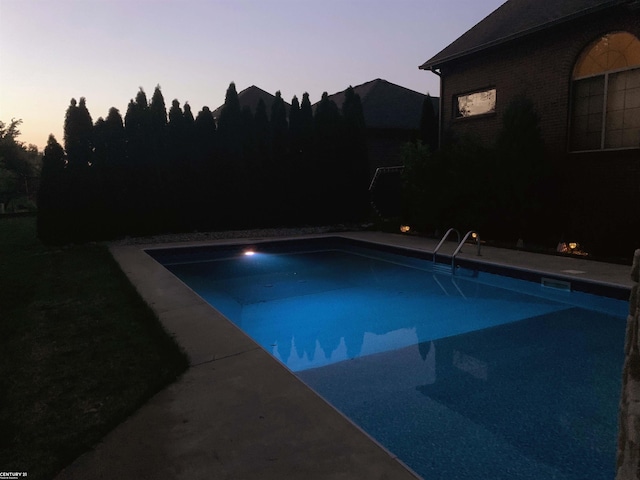 pool at dusk with an outdoor pool