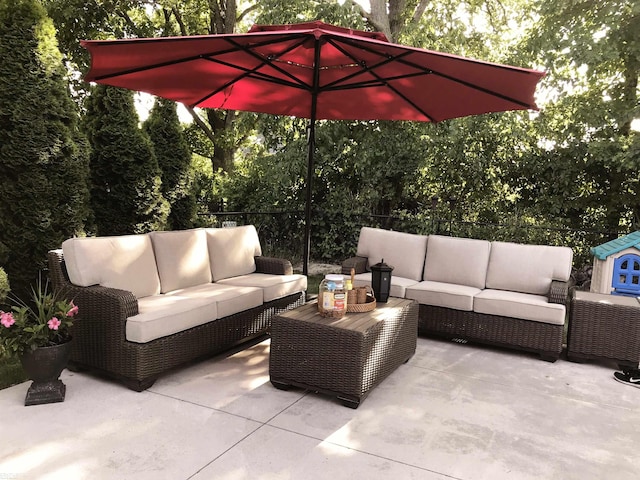 view of patio / terrace featuring an outdoor living space and fence