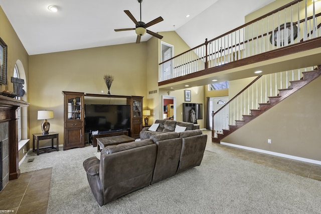 tiled living area with baseboards, high vaulted ceiling, a fireplace, stairs, and carpet flooring