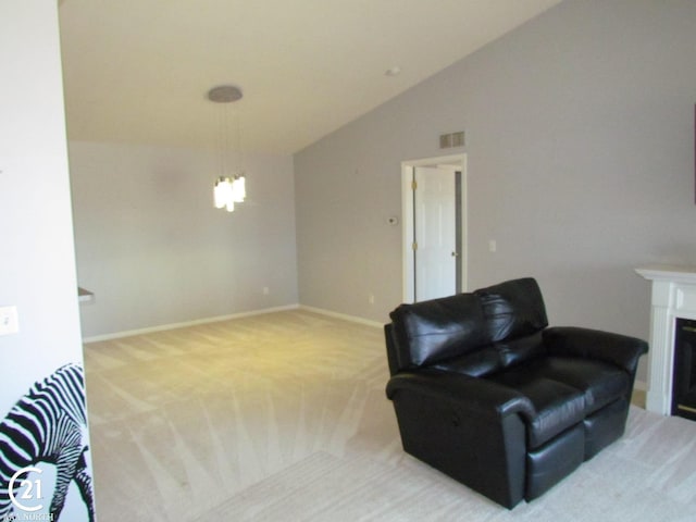 sitting room featuring visible vents, light carpet, a fireplace, baseboards, and vaulted ceiling