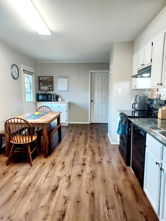 dining area featuring light wood-style floors and baseboards