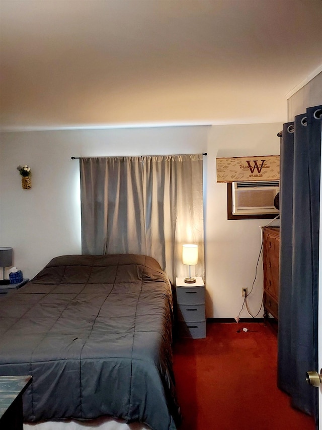 bedroom with an AC wall unit and carpet flooring