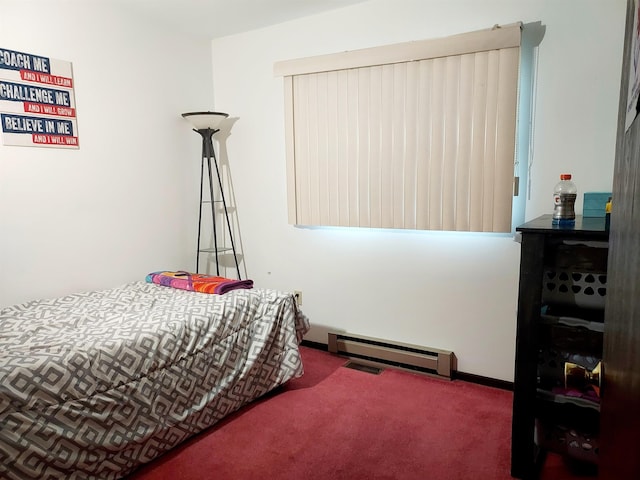 bedroom featuring visible vents, baseboards, a baseboard heating unit, and carpet