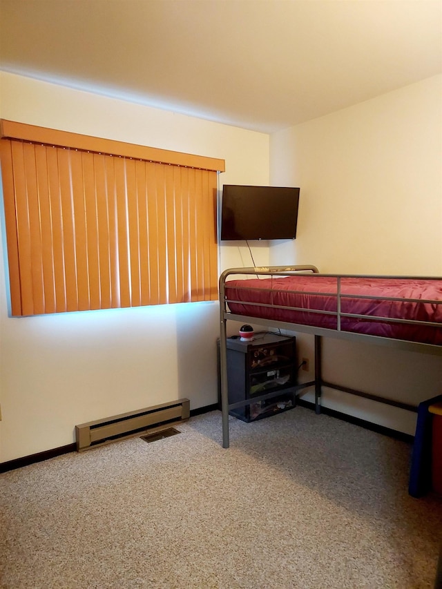 carpeted bedroom with a baseboard heating unit