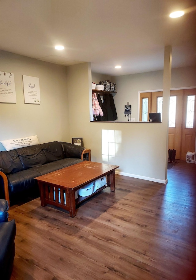 living area featuring recessed lighting, wood finished floors, and baseboards