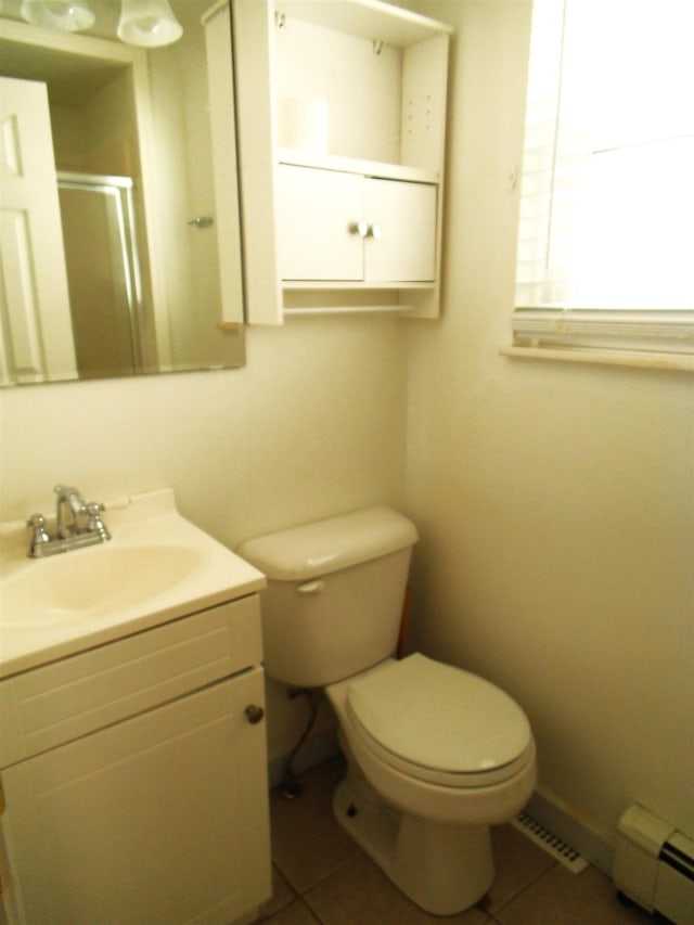 full bath with tile patterned flooring, a shower stall, vanity, and a baseboard heating unit