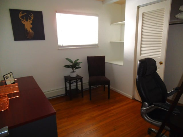 office area featuring baseboards and wood finished floors