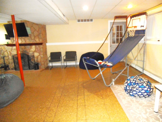 rec room featuring visible vents, a fireplace, and baseboards