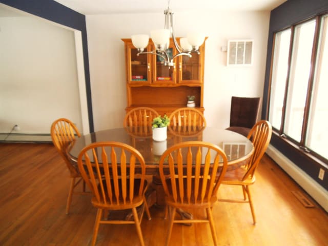 dining room featuring wood finished floors, visible vents, and a wealth of natural light