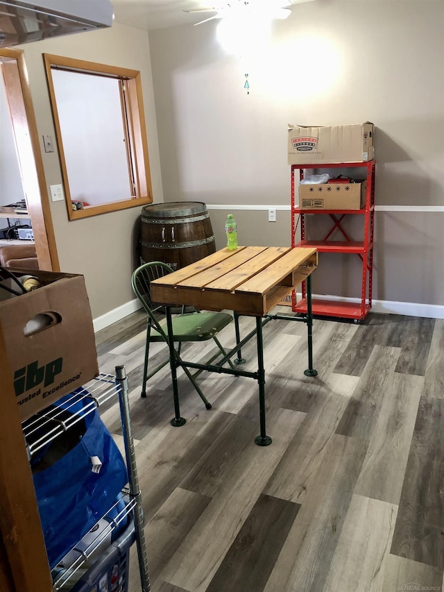 interior space featuring baseboards and wood finished floors