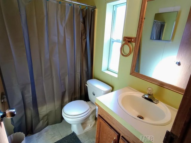 bathroom featuring tile patterned floors, toilet, a shower with shower curtain, and vanity