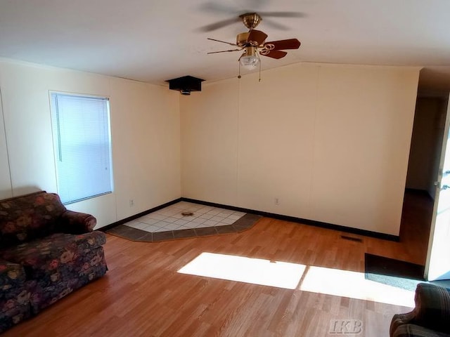 unfurnished living room with lofted ceiling, light wood-style flooring, and a ceiling fan