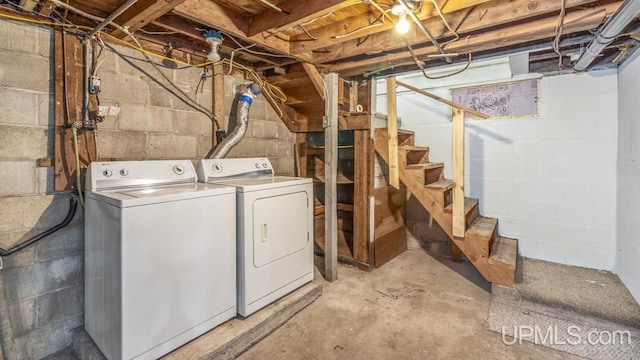 unfinished below grade area with stairs and separate washer and dryer