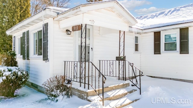 view of snow covered property entrance