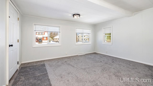 carpeted spare room featuring a baseboard heating unit, beam ceiling, baseboards, and ornamental molding