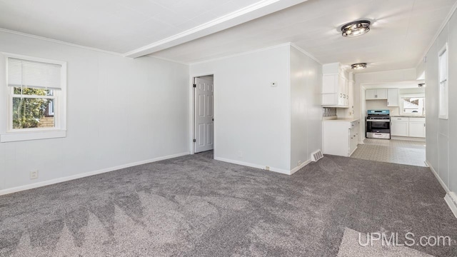 unfurnished room with visible vents, baseboards, light colored carpet, and crown molding