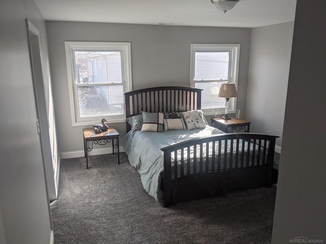 carpeted bedroom with multiple windows and baseboards