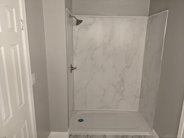 full bath with a marble finish shower