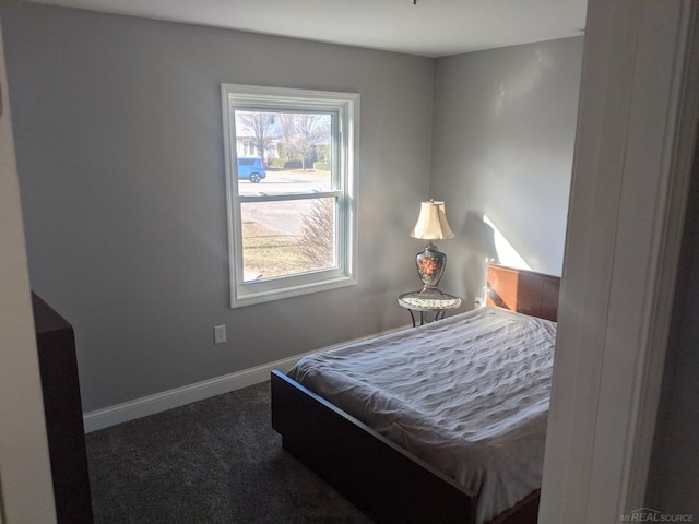 bedroom featuring carpet flooring and baseboards