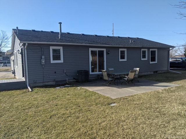 rear view of property featuring a yard, a patio area, cooling unit, and a shingled roof