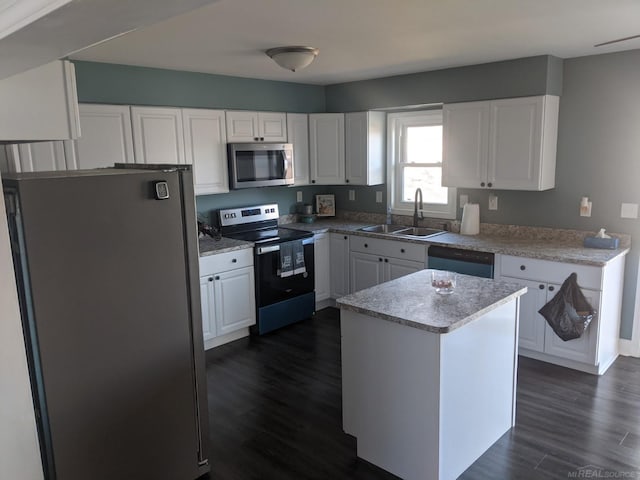 kitchen featuring a sink, dark wood-type flooring, appliances with stainless steel finishes, and white cabinetry