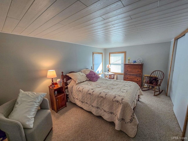 carpeted bedroom featuring wooden ceiling