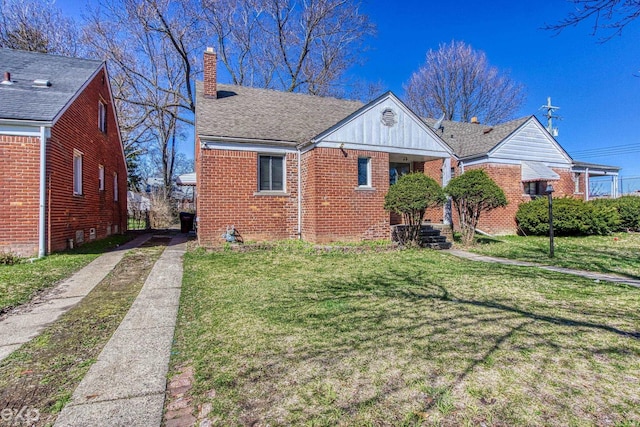 view of property exterior featuring a yard, brick siding, a chimney, and a shingled roof