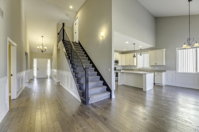 interior space featuring a notable chandelier, stairs, and wood-type flooring