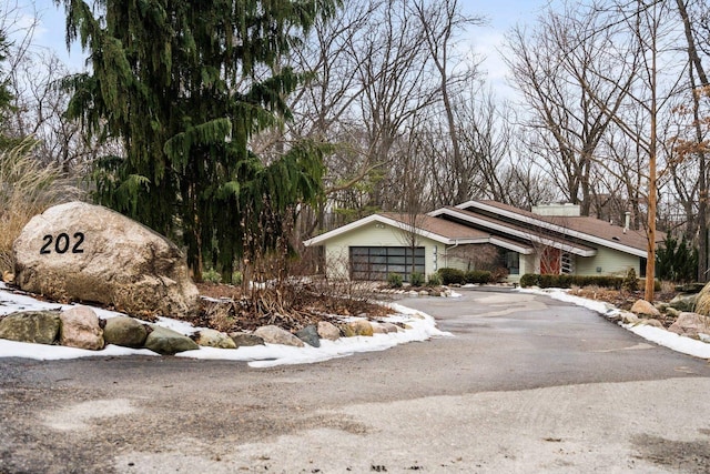 view of front of home featuring aphalt driveway and an attached garage