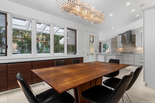 dining area with light tile patterned floors, lofted ceiling, and recessed lighting