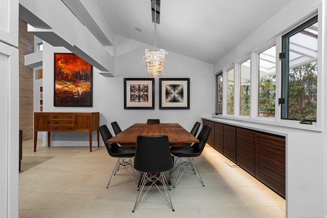 dining space featuring lofted ceiling, light tile patterned floors, and a chandelier