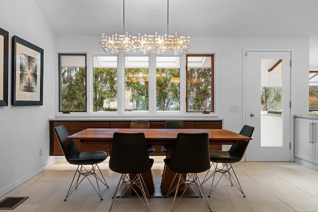 dining space featuring light tile patterned floors, baseboards, and visible vents