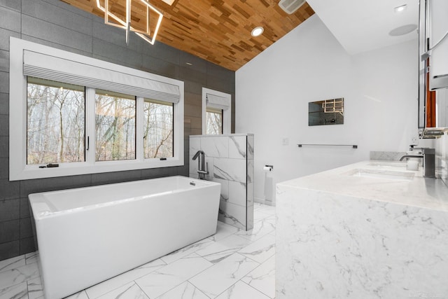 full bath with vanity, lofted ceiling, a freestanding tub, wooden ceiling, and marble finish floor