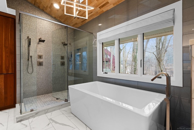 bathroom with a shower stall, a freestanding bath, lofted ceiling, wooden ceiling, and marble finish floor