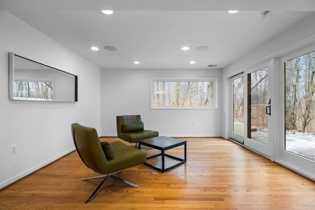 living area featuring visible vents, recessed lighting, baseboards, and light wood-style floors