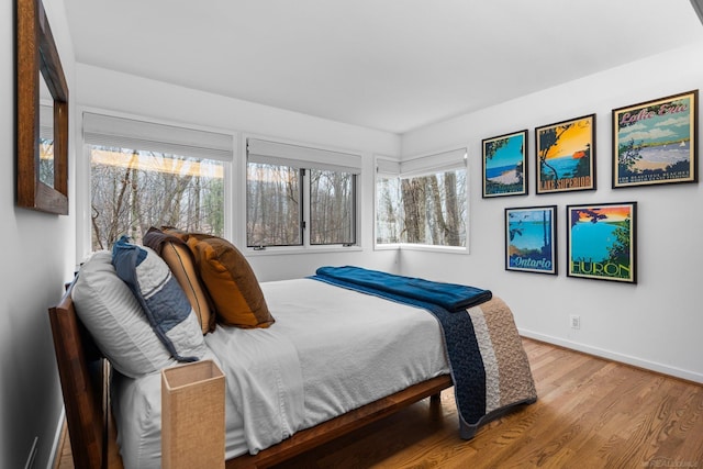 bedroom featuring baseboards and wood finished floors