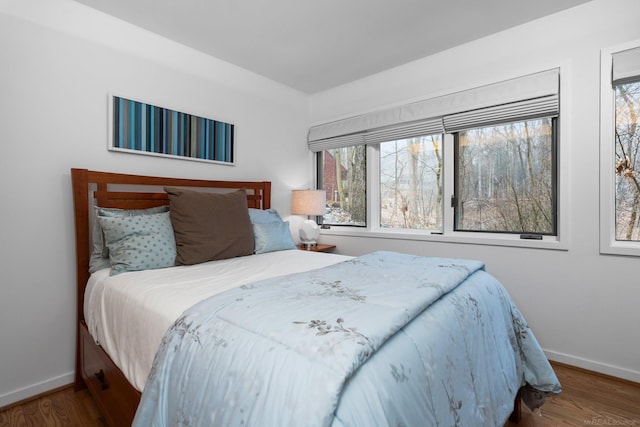 bedroom featuring wood finished floors and baseboards