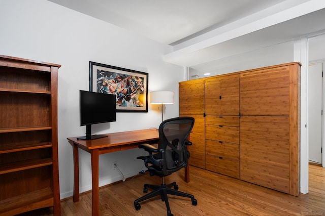 home office featuring baseboards and wood finished floors