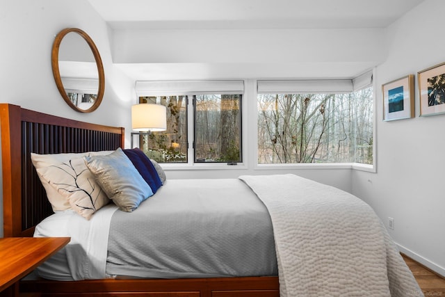 bedroom featuring wood finished floors and baseboards