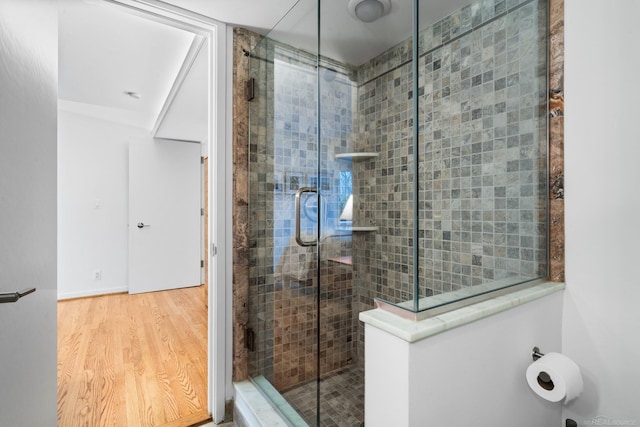 bathroom featuring a shower stall and wood finished floors