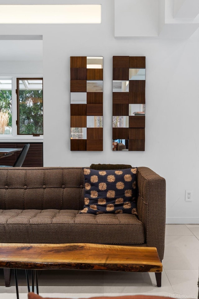 tiled living area featuring baseboards