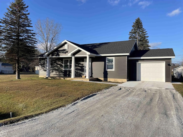 ranch-style home featuring a garage, a front lawn, roof with shingles, and driveway