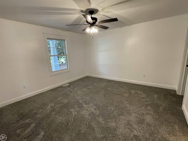 unfurnished room with ceiling fan, baseboards, and dark colored carpet