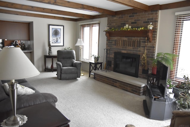 carpeted living room with beam ceiling and a brick fireplace