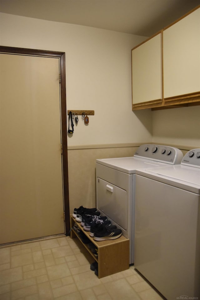 washroom with cabinet space and independent washer and dryer